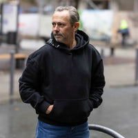 Schwarzer frankfurtkind oversized Hoodie von frankfurtkind mit Kapuzenprint, getragen von einem männlichen Model.